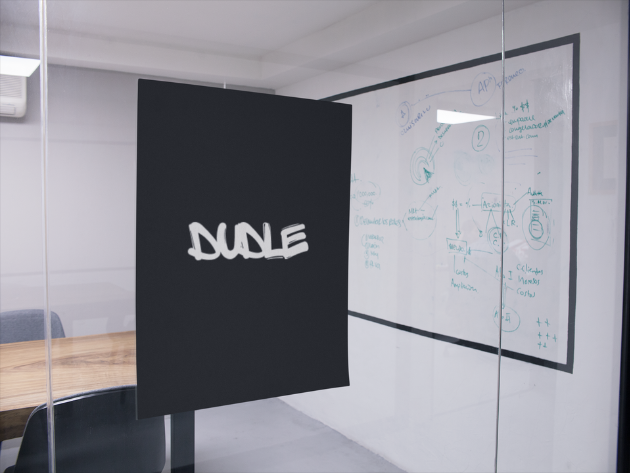 Dudle logo poster displayed in an office meeting room with whiteboard in background